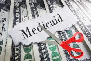 Trump Threatens to Pull Medicaid Funds From All 50 States Over Fraud Medicaid,Newspaper,Headline,On,Cash,With,Scissors,About,To,Cut