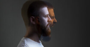12 Common Behaviors of People Hiding Inner Anger Side view portrait of two-faced man in calm serious and angry screaming expression. Different emotion inside and outside mood. Internally suffering, dissociative identity disorder. Double exposure
