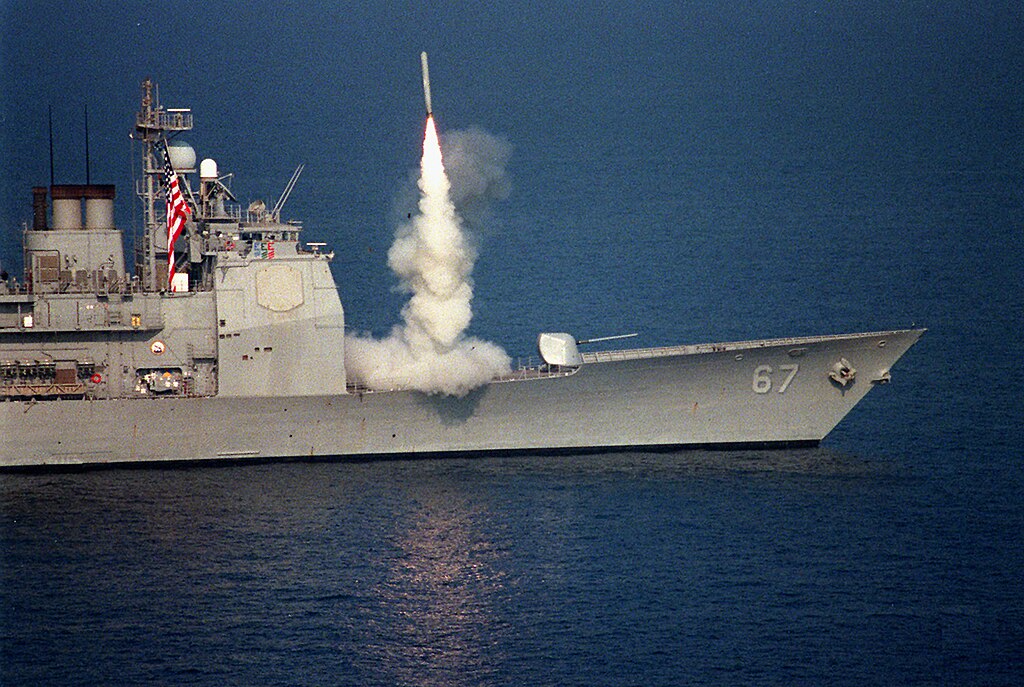 US Navy ship launching a Tomahawk cruise missile over the ocean, a weapon once used to deliver graphite bombs