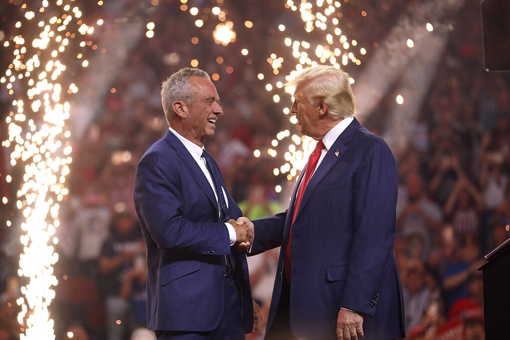RFK Jr. and Trump shake hands at Arizona rally, showing their partnership.