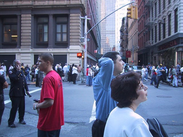 onlookers gather in the street on 9/11