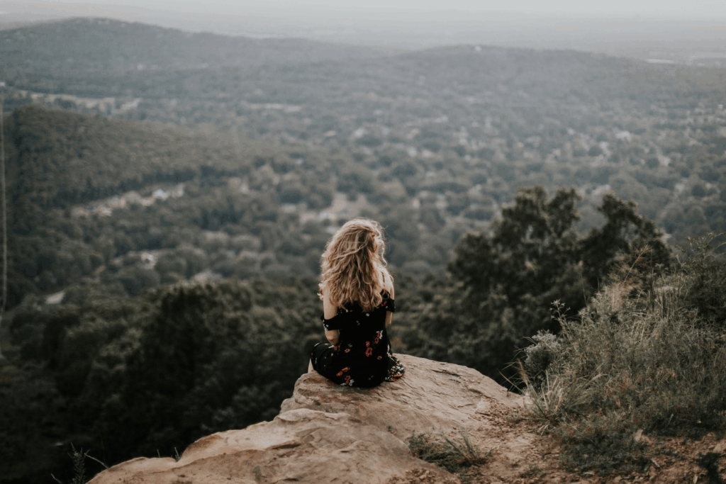 independent woman on a mountain