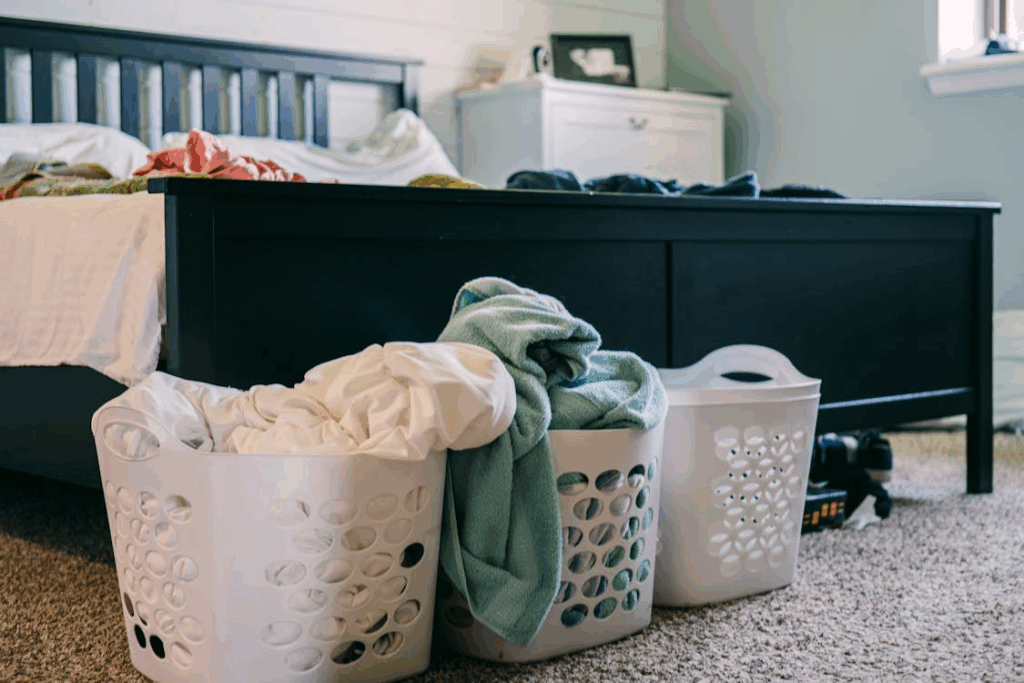 Baskets with Laundry Standing on the Floor by the Bed