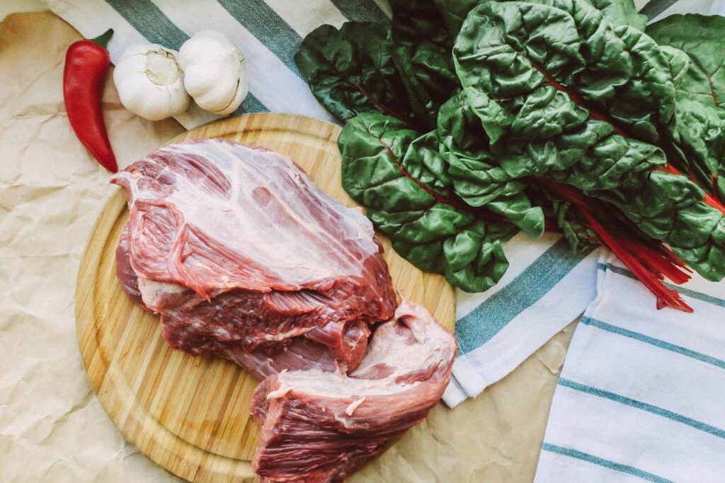 Raw Meat on Brown Wooden Chopping Board