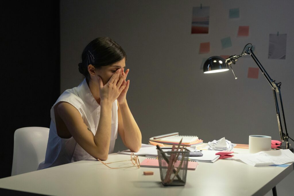 stressed overwhelmed woman at a desk