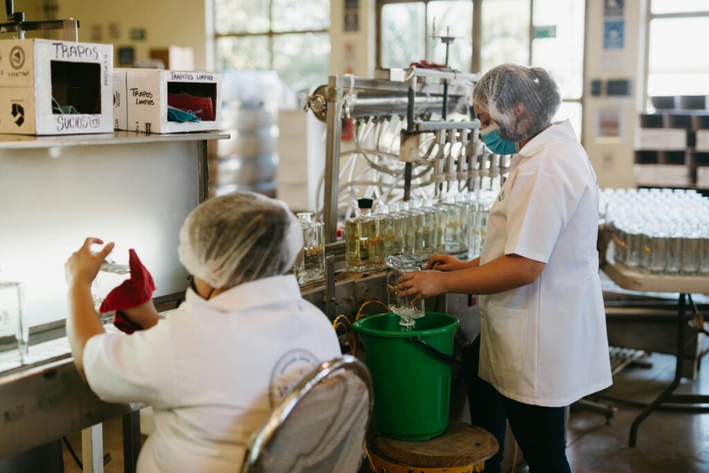 Workers Cleaning Glass Bottles
