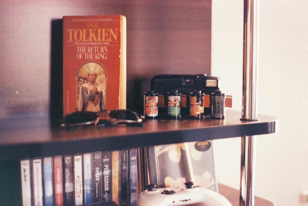 Sunglasses and Vintage Camera on a Bookshelf

