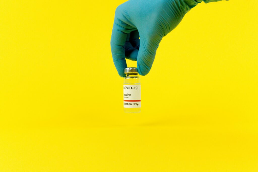 Person Wearing a Latex Glove Holding a Vaccine

