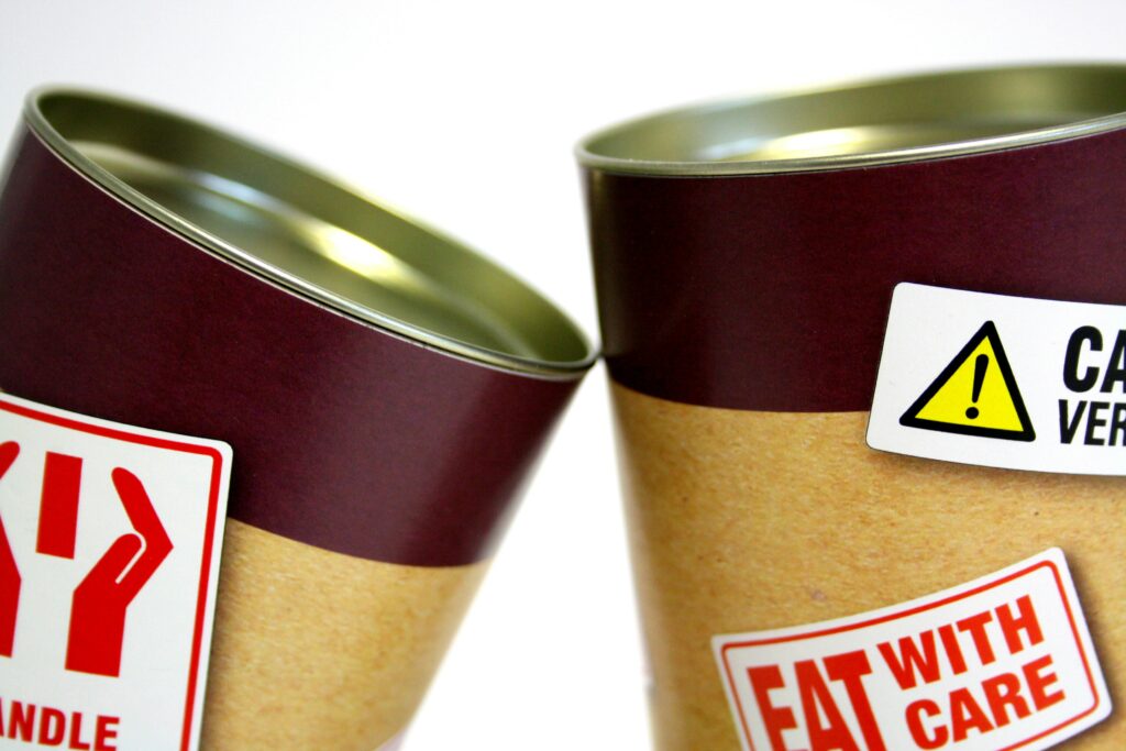 Two Cans With Signages
