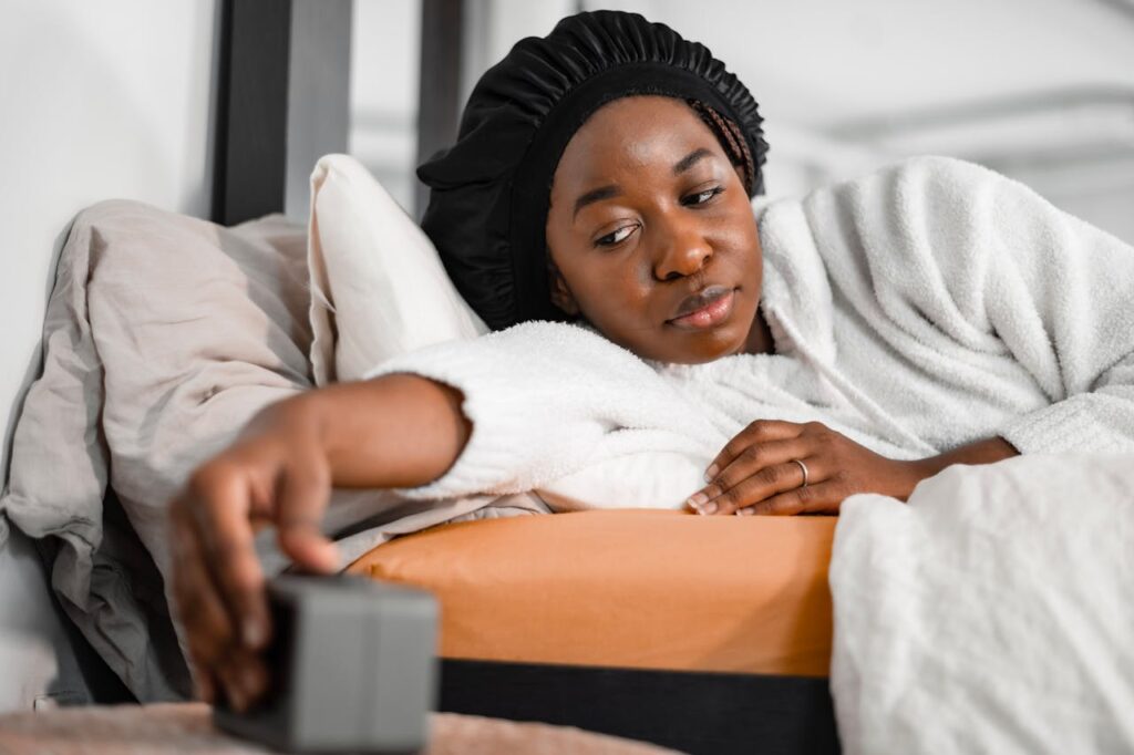 Woman in Bed Switching Alarm Clock Off