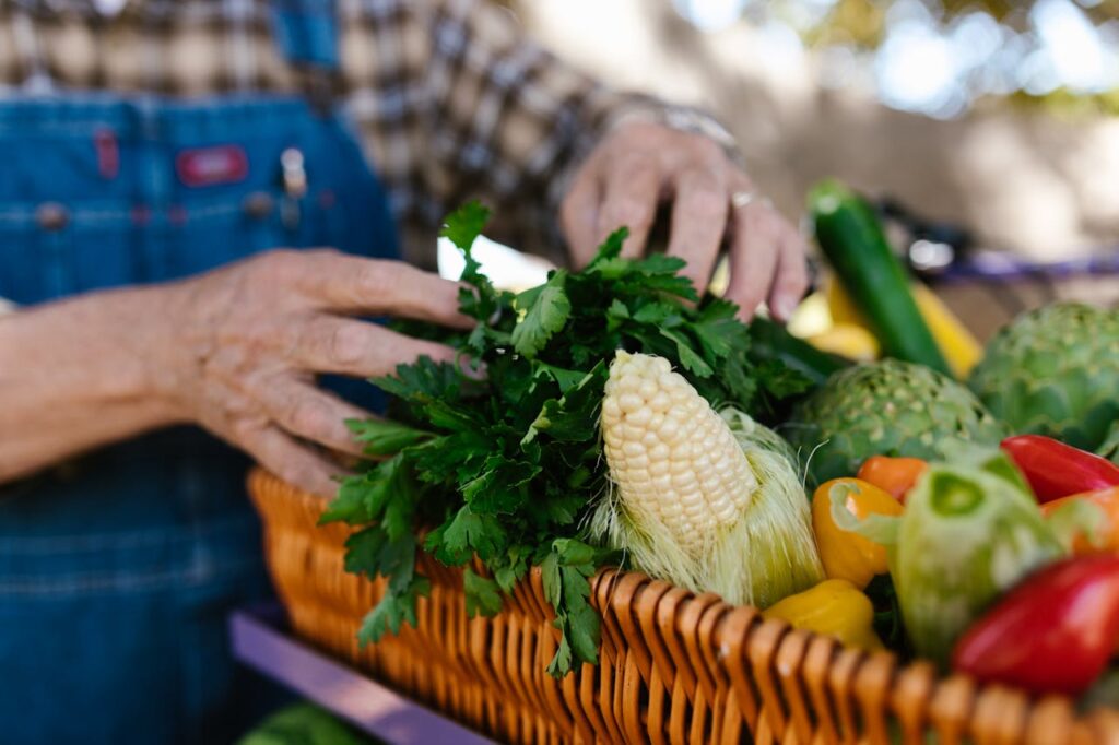 A Close-Up Shot of a Person Arranging Vegetables in a Basket
