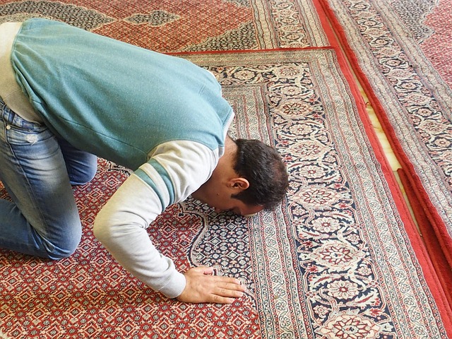 man praying on mat