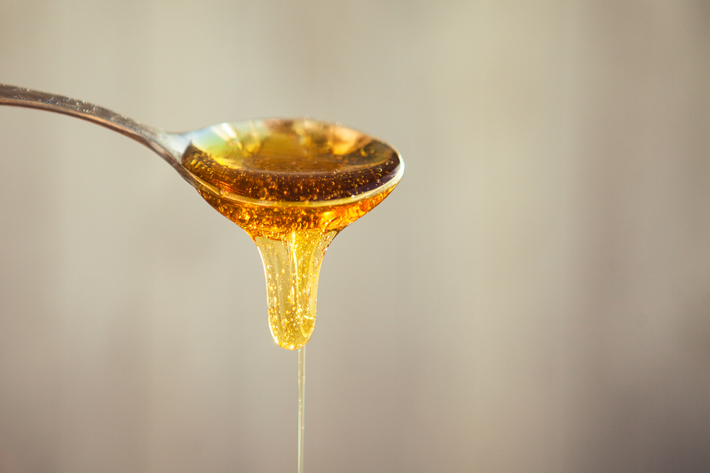 Honey dropping from the spoon