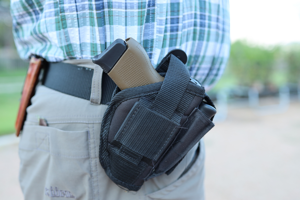 Comfort, Texas - June 16th, 2021: Man in Texas is carrying a gun holstered and for all to see. 