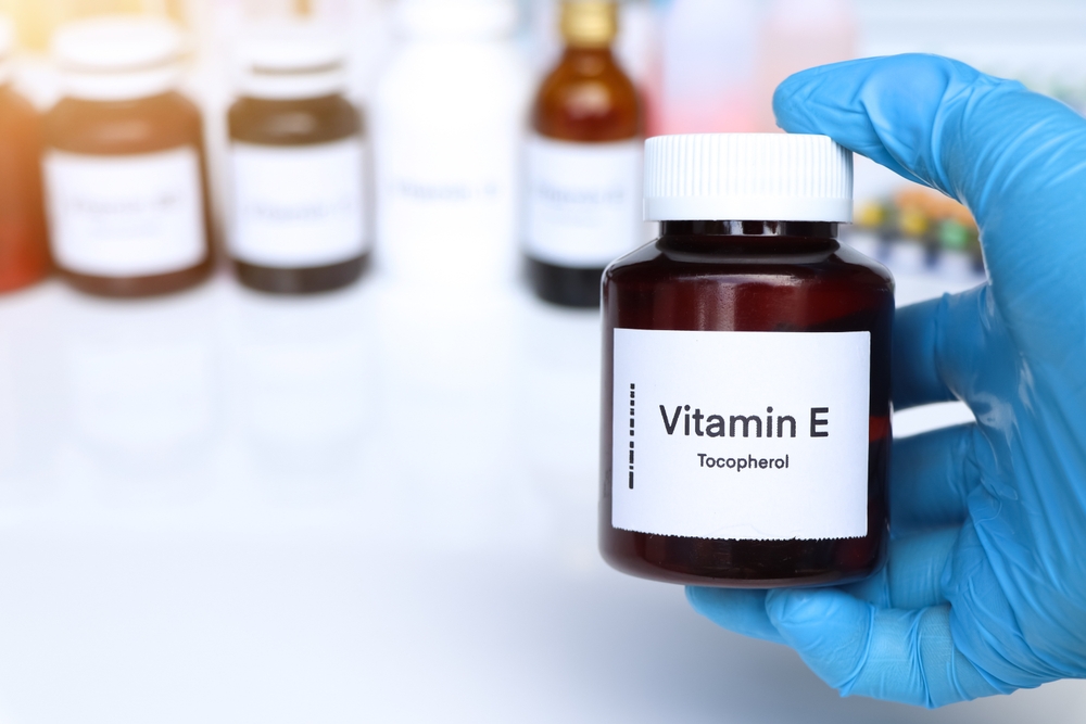 Vitamin E pills in a bottle, food supplement for health or used to treat disease