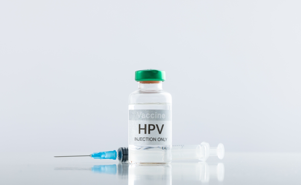 Composition of hpv vaccine vial and syringe on white background with copy space. Medicine, medical services, healthcare and health awareness concept.
