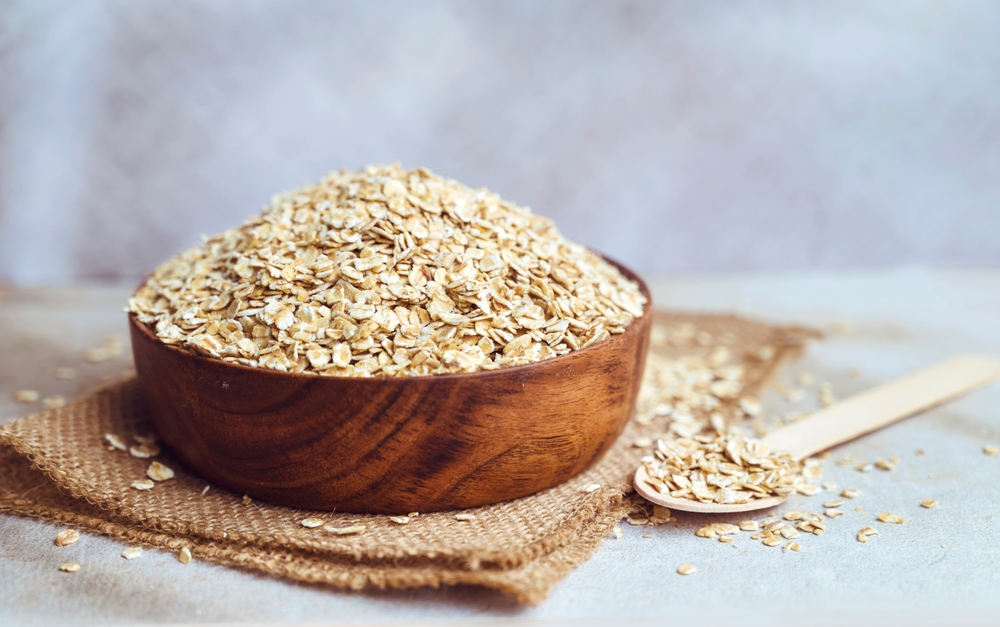 Oats in wooden bowl . Healthy food