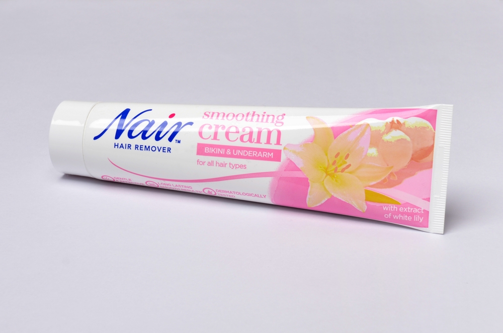 HULL, UK - Aug 24th, 2024: Tube of Nair brand hair remover soothing cream for bikini and underarm extract of white lily on white background