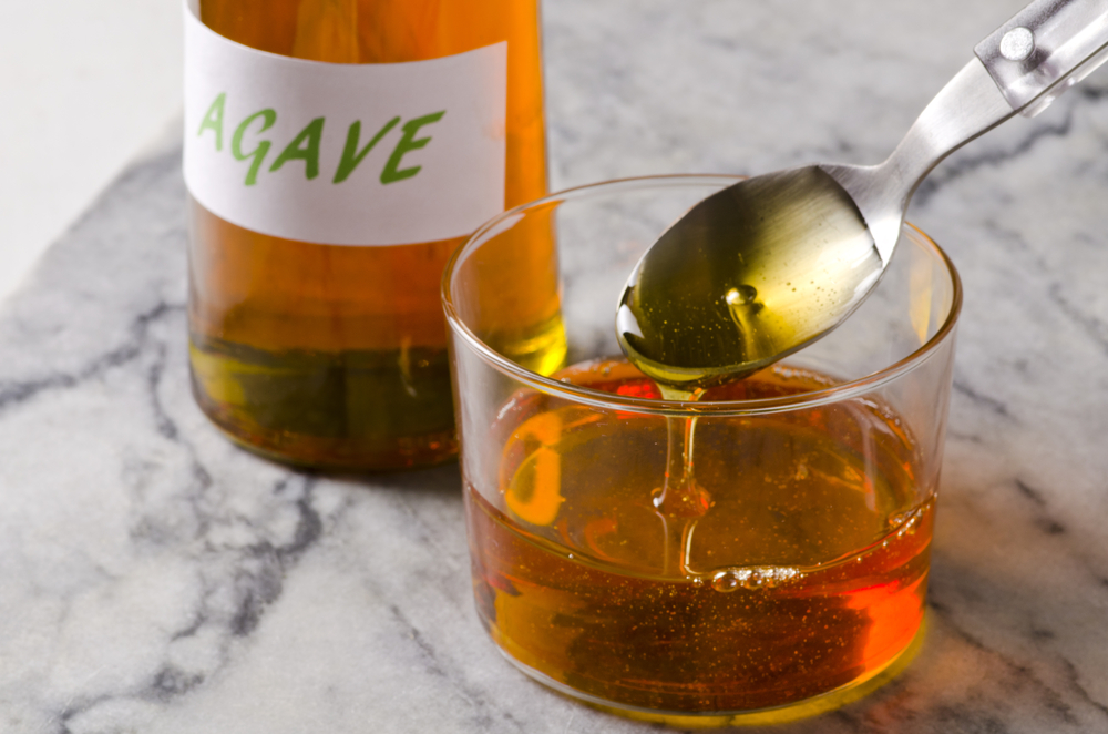 Agave Syrup pouring on a glass. Alternative sweetener to sugar. Selective focus.