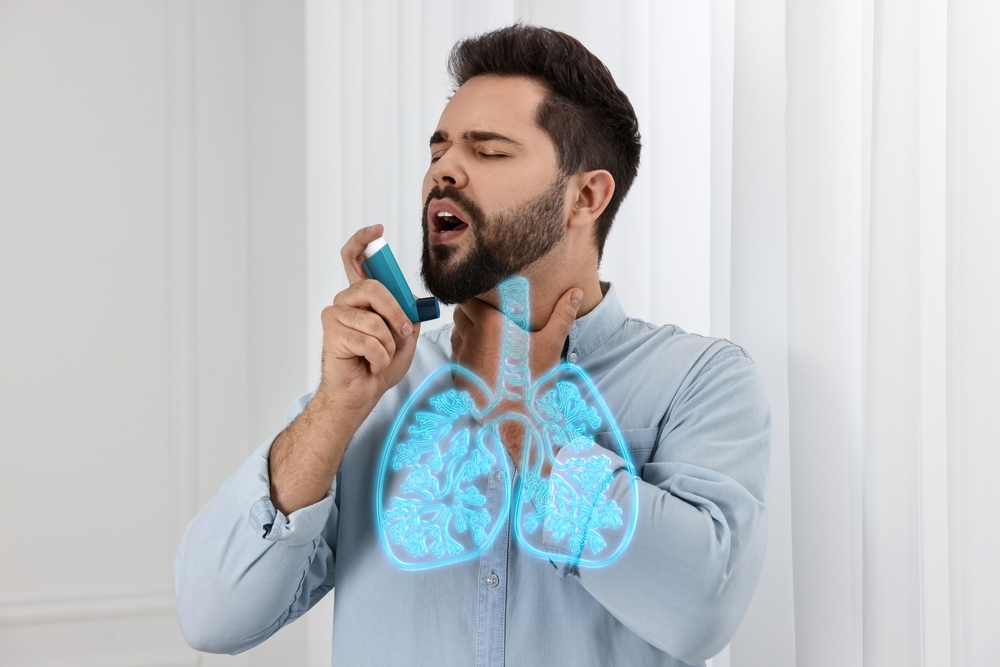 Young with asthma man using spray at home. Illustration of lungs