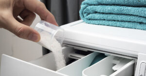 The Safest Laundry Detergents: A Simple Guide to Non-Toxic, Eco-Friendly Washing powdered laundry detergent being poured into washing machine