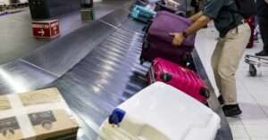 Flying Soon? Avoid These Common Luggage Colors, Airline Advises luggage on a carousel at an airport