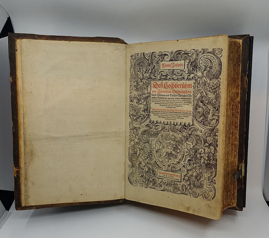 Open pages of a 1581 German translation of Josephus's "The Jewish War" from the Jewish Museum of Switzerland collection, showing ornate Renaissance-era typography and decorative borders.