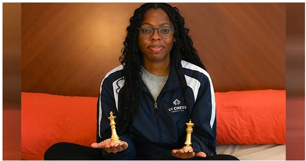 Jessica holding chess pieces