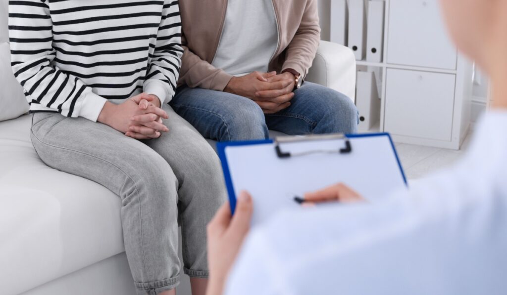 Couple having appointment with STD specialist in clinic, closeup
