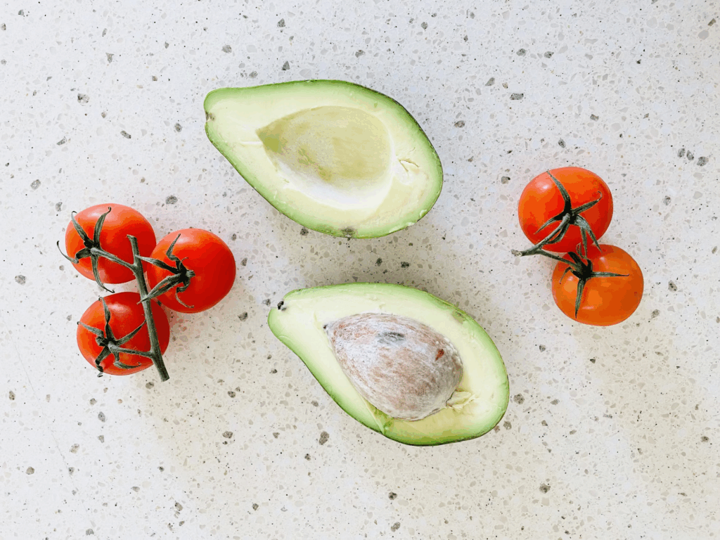 tomatoes and avocados on linoleum counter