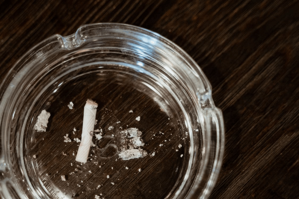 Close-Up Shot of Cigarette Butt in a Clear Glass Round Ashtray leads to kidney damage