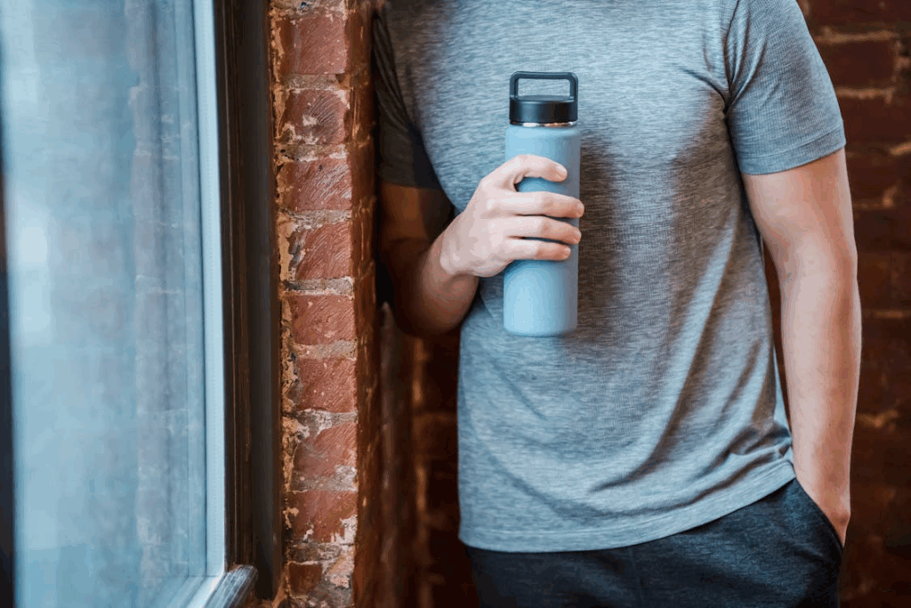 Crop sportsman with water bottle