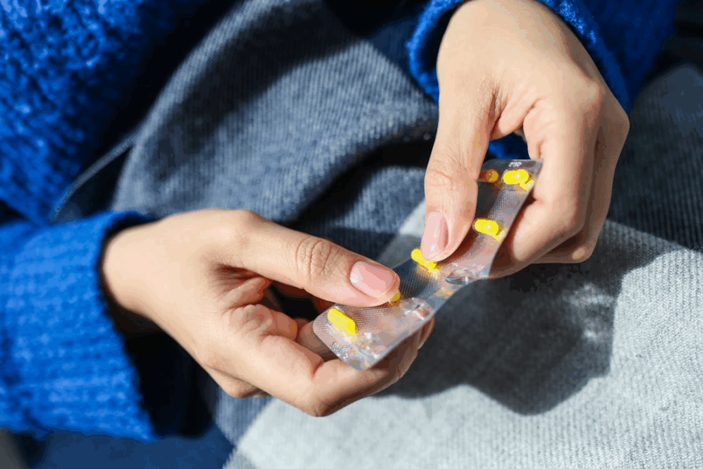 Person Holding Blister Pack of painkillers leads to kidney damage