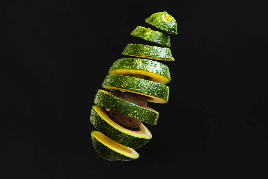 sliced avocado on black background