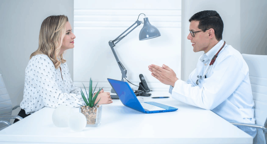 A doctor is talking to a woman in a White Sleeve Shirt