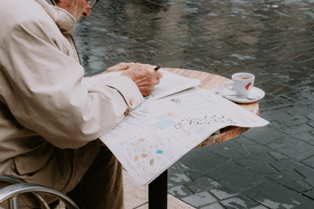 elderly person doing crossword
