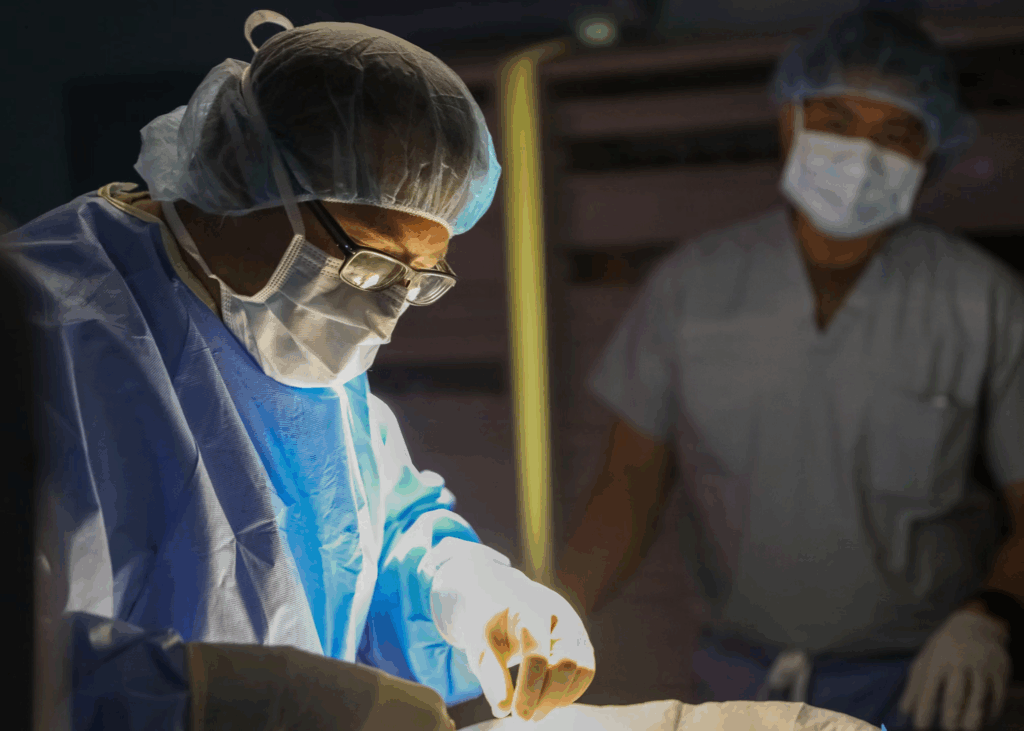 surgeon performing on patient under anesthesia