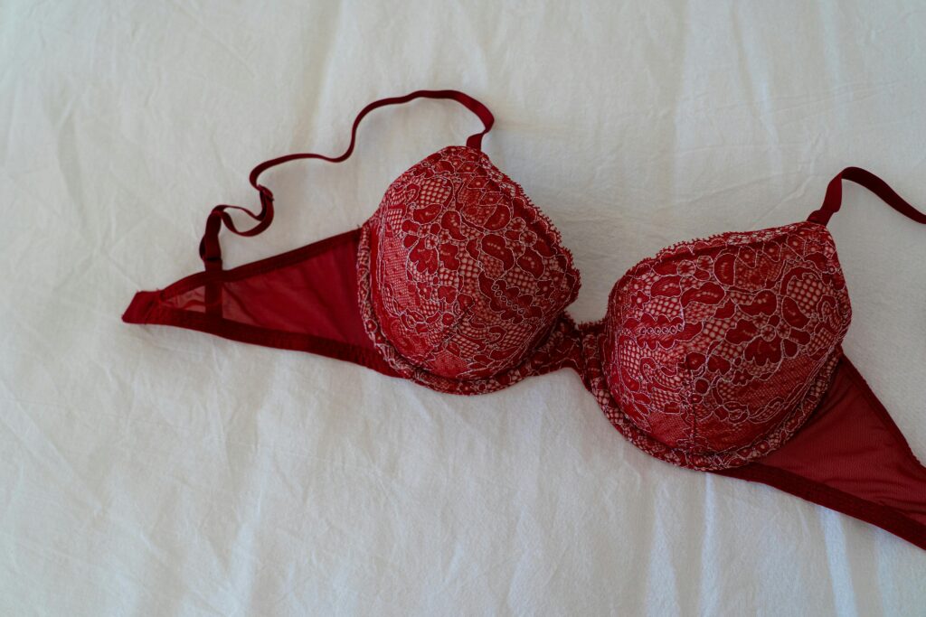 Red Brassiere on White Textile

