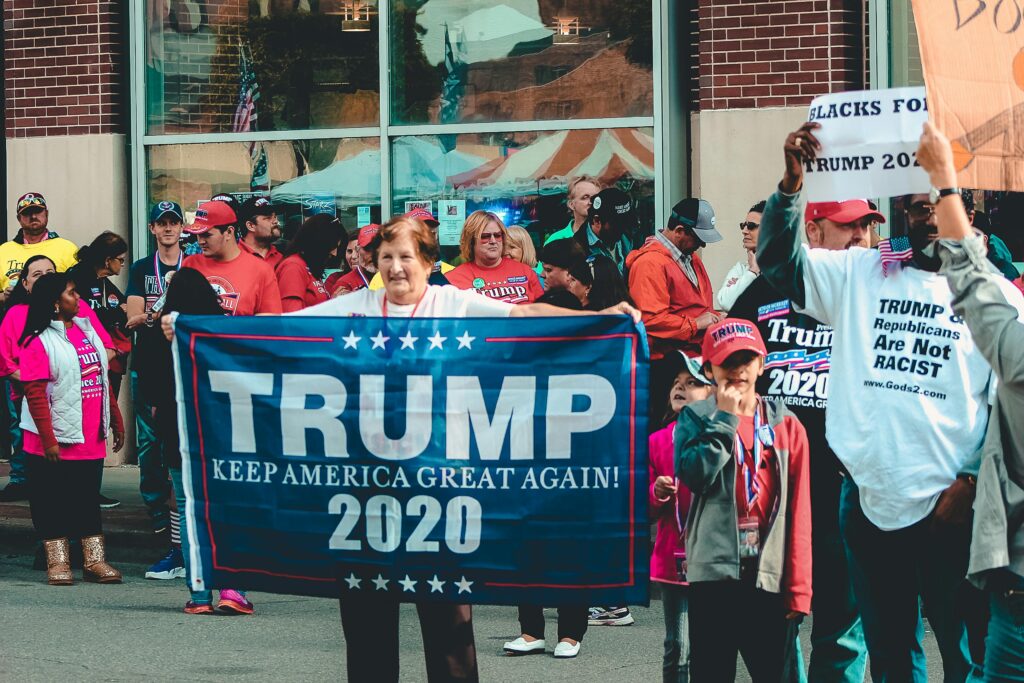 Woman Holding Trump Keep America Great Again 2020 Banner
