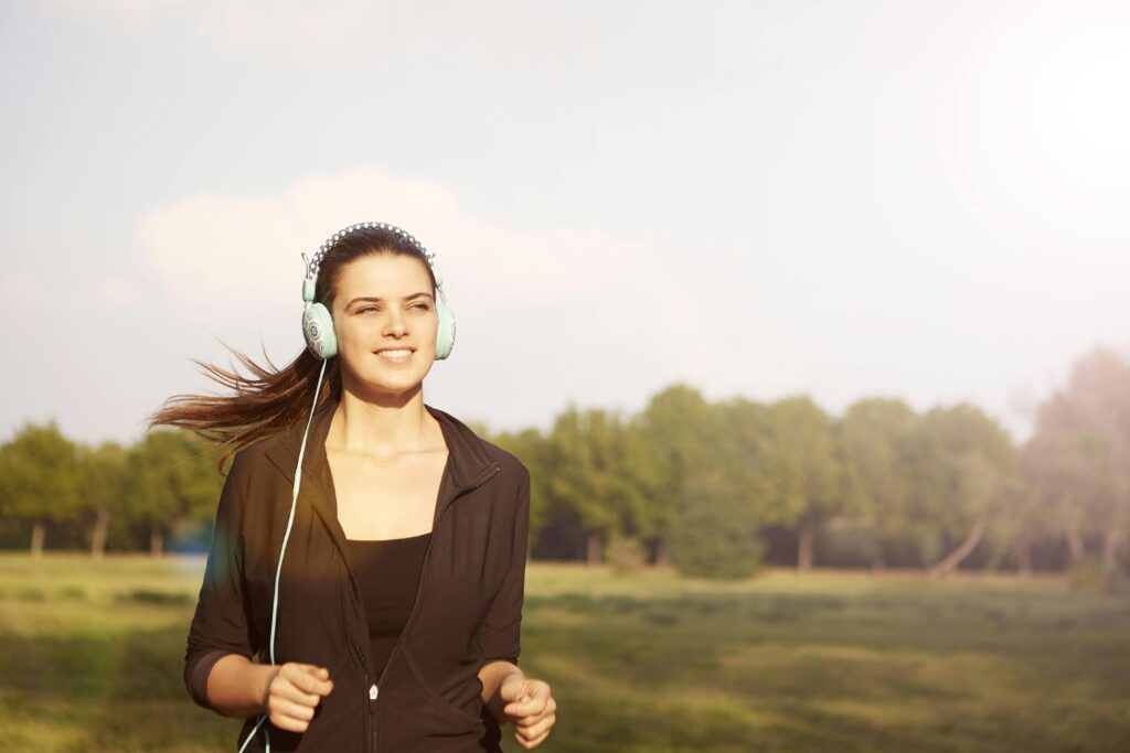 Woman Wearing Black Jacket While Listening to Music
