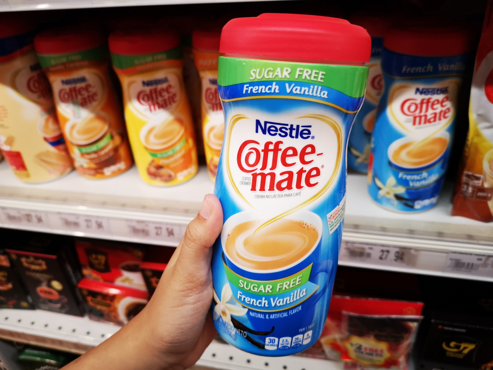 Subang Jaya, Malaysia - 26 August 2018 : Hand hold a bottle of NESTLE Coffee-Mate French Vanilla Sugar Free in the supermarket 