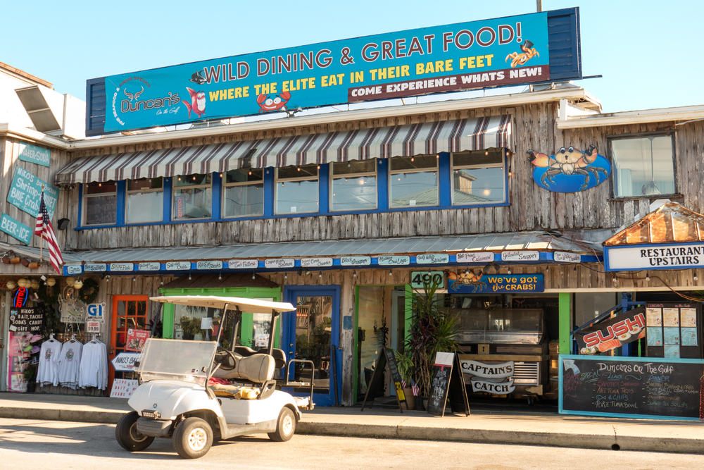 CEDAR KEY, FLORIDA - NOVEMBER 26, 2019:  Shops and restaurants are open for business along the Gulf of Mexico waterfront in Cedar Key, Florida