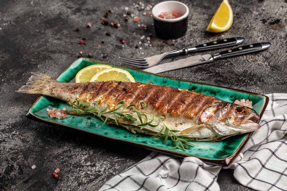 Baked trout fish, Grilled trout barbeque with lemon, Healthy eating concept. banner, menu, recipe place for text, top view,