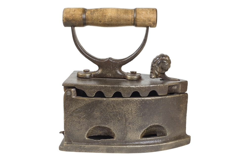 An old iron, insulated on a white background. Close-up.

