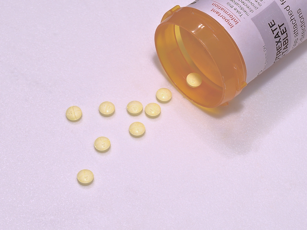 Two and a half milligram Methotrexate Sodium pills on a textured white surface.