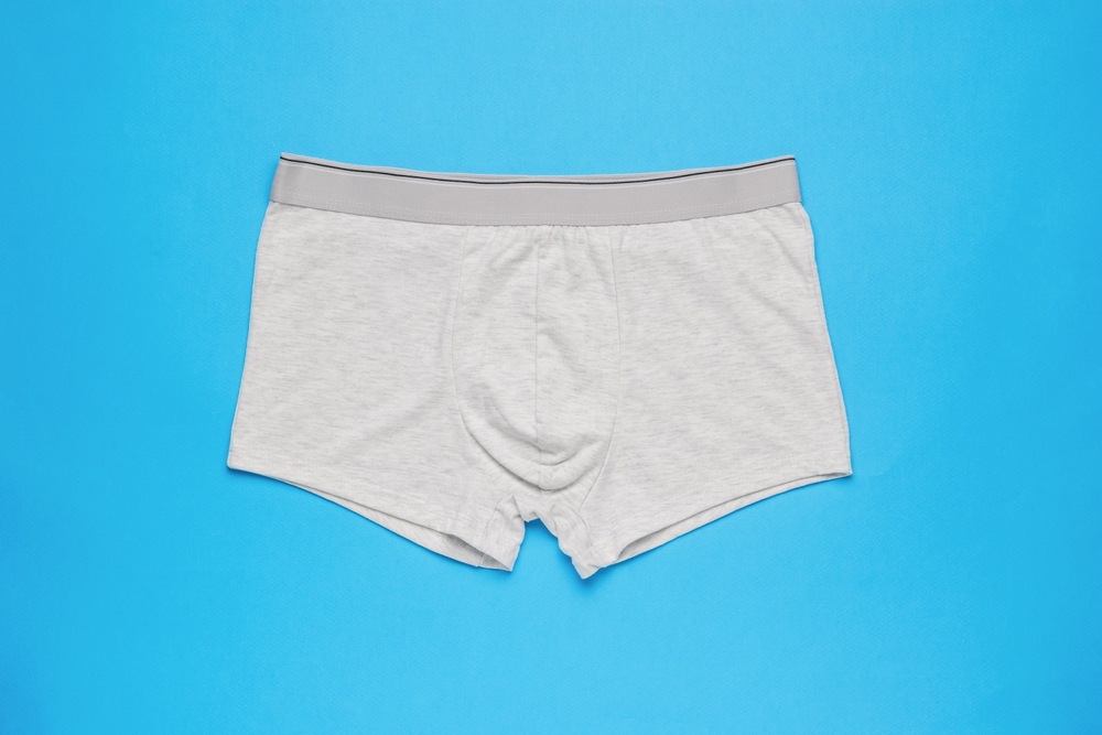 Light men's underpants on a light blue background. Minimal concept of men's underwear. Flat lay.