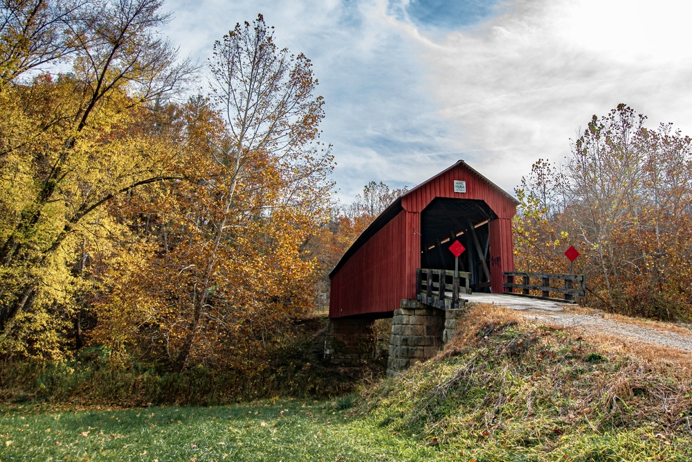 Marietta, Ohio, USA-Oct. 25, 2022: Landscape of Hune Covered Bridge, a Long truss, single span bridge built in 1879 over the Little Muskingum River and restored in 1998.