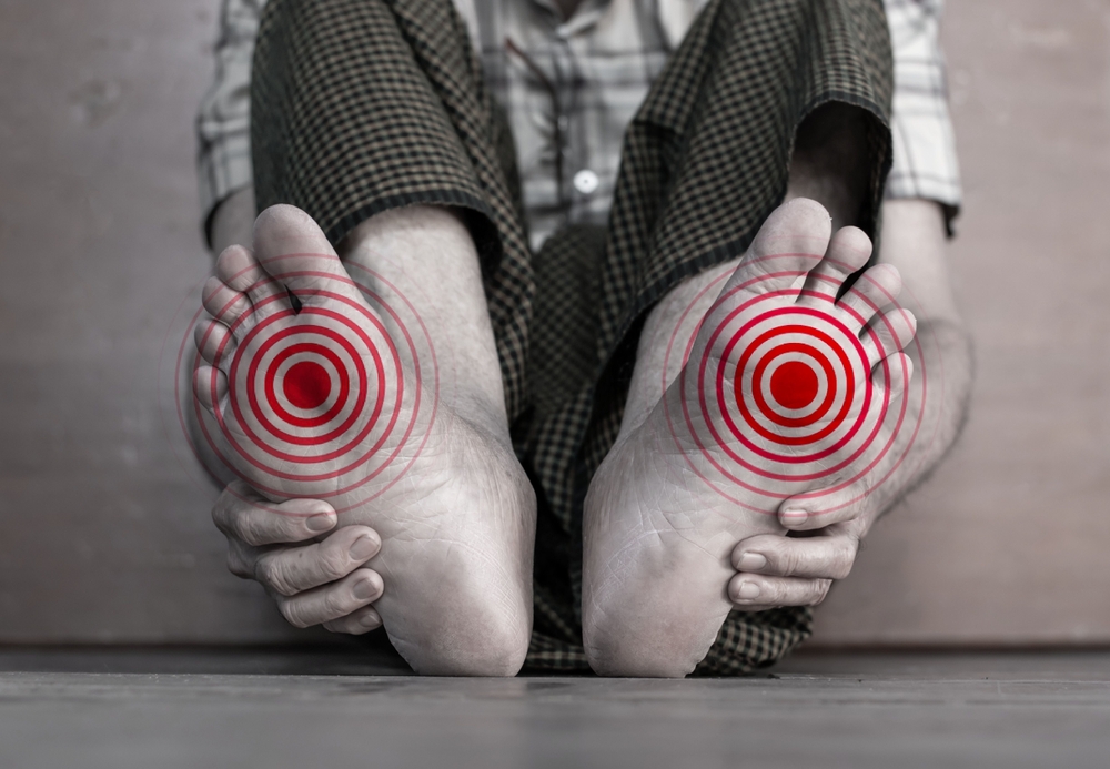 Tingling and burning sensation in foot of Asian elder man with diabetes. Foot pain. Sensory neuropathy problems. Foot nerves problems. Plantar fasciitis.