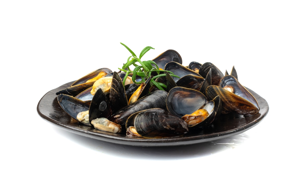 Mussels Pile on Black Plate Isolated, Open Shellfish, Seafood, Mussels Meat, Cooked Clams on White Background