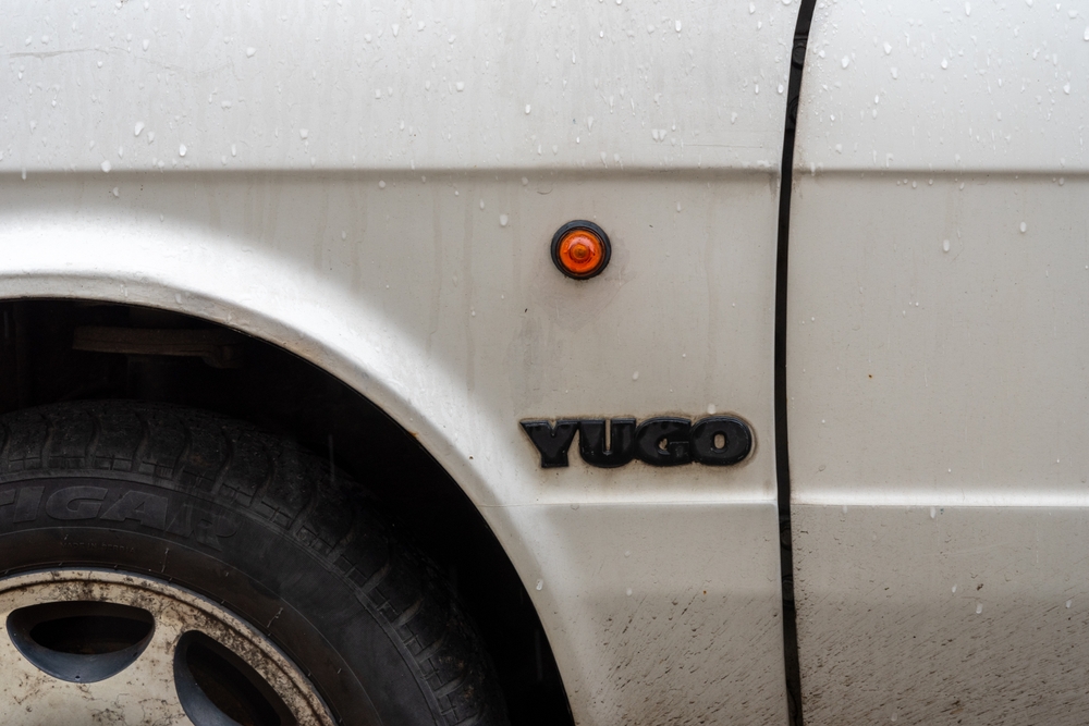 Belgrade, Serbia. May 324 2024. Side detail showing the round indicator and logo of the classic Yugo car, made in Yugoslavia. 